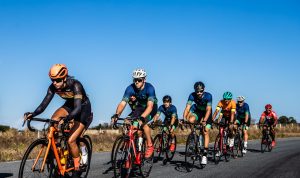 group of men riding bicycles on road